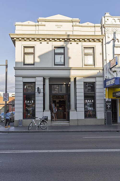 The former Union Bank building at 244 King Street, a two storey stucco facade with a pedimented cornice reading ERECTED 1922 above a colonnaded shopfront.