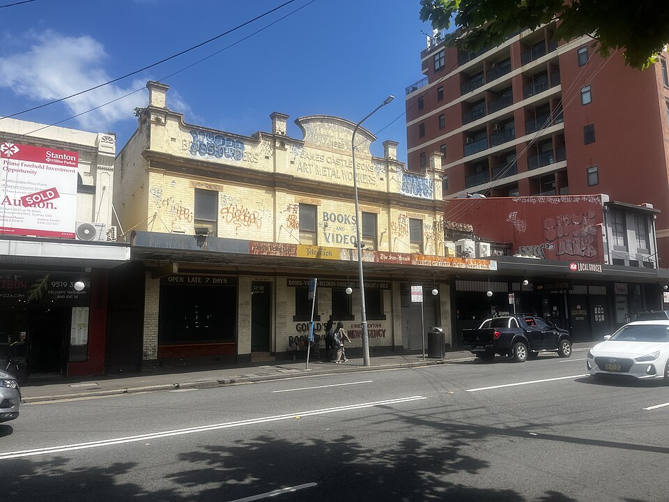 The former Gould's Book Arcade storefront near the top of King Street, its parapet still lettered BOOKS AND VIDEO above shuttered windows, empty since the shop moved south in 2018.