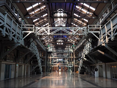 The wharf's own timber trussed interior, a long atrium of steel girders and skylights running the length of the building.