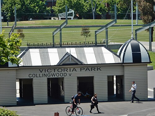 Victoria Park's weatherboard grandstand entrance, a domed corner turret over open archways lettered VICTORIA PARK, the fenced oval behind.