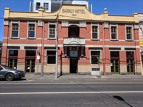 The Barkly Hotel, a symmetrical red brick and rendered two storey corner hotel facing the road.