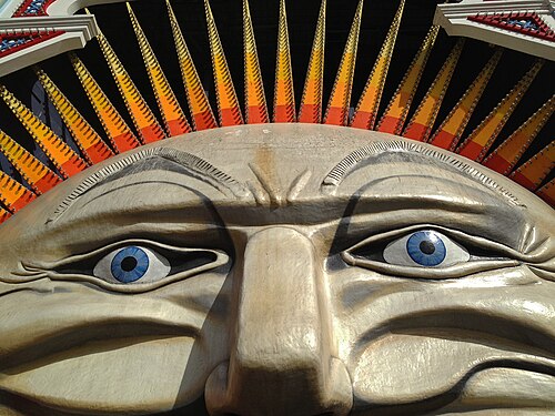Luna Park's sculpted Mouth entrance, a giant face with a gaping doorway under yellow and orange spires.