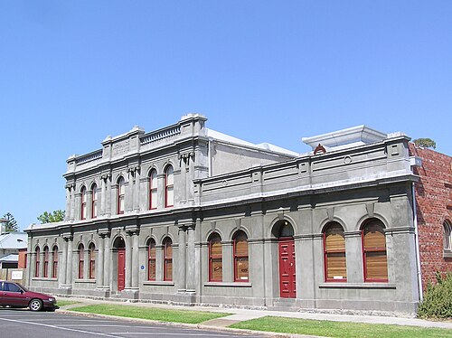 The Williamstown Mechanics Institute on Electra Street, a rendered classical facade with arched windows, pilasters and parapet lettering.