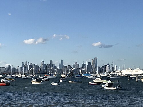 Moored yachts in the boat harbour with Melbourne's city skyline across the bay.