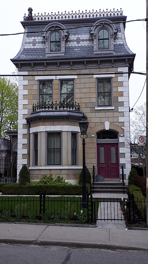 The Francis Shields House on Sackville Street, a Second Empire mansion in banded stone with a mansard roof, arched dormer windows and wrought iron cresting along the roofline.