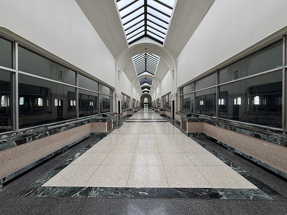 A marble lined corridor inside the plant, arched skylights running the length of the ceiling above a terrazzo floor.