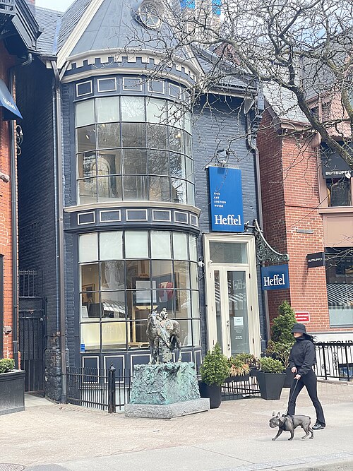 The Heffel Fine Art Auction House on Hazelton Avenue, a turreted Victorian house converted into a gallery, with a bronze sculpture on the sidewalk outside its entrance.