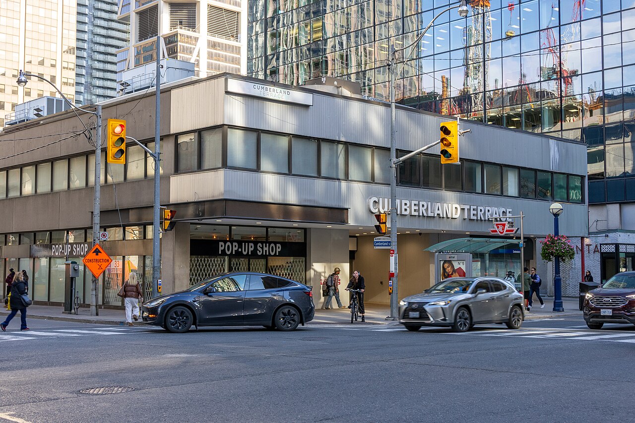 The former Cumberland Terrace shopping centre on Cumberland Street, glass office towers rising across the street and cars stopped at the lights.