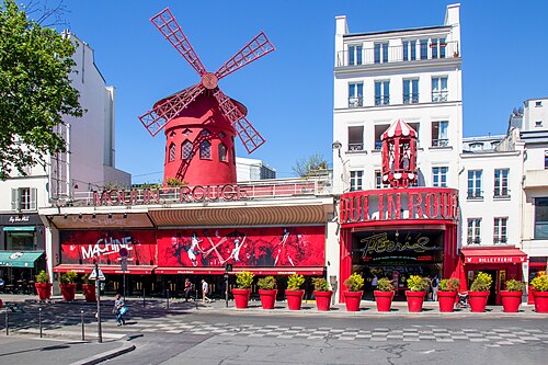 The Moulin Rouge at Place Blanche, the red windmill on the roof and the red frontage below it, with the La Machine entrance next door.