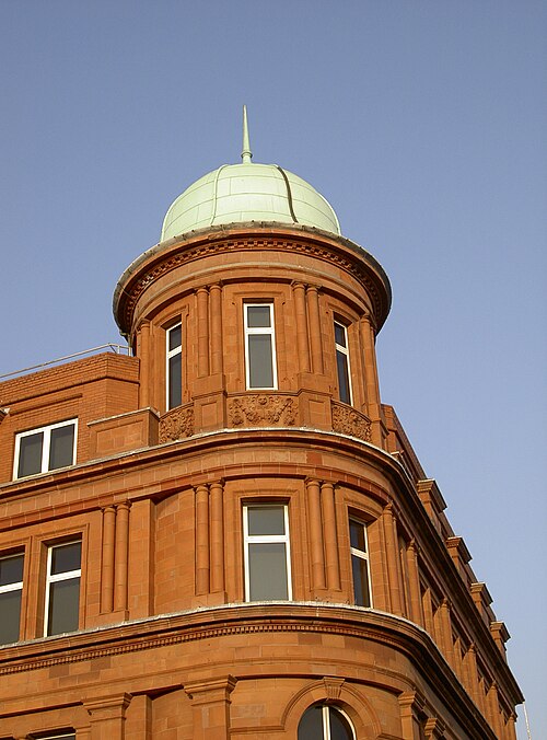 The preserved corner of the former W.D. and H.O. Wills tobacco factory at East Street and Lombard Street, red brick and terracotta under a domed corner tower.