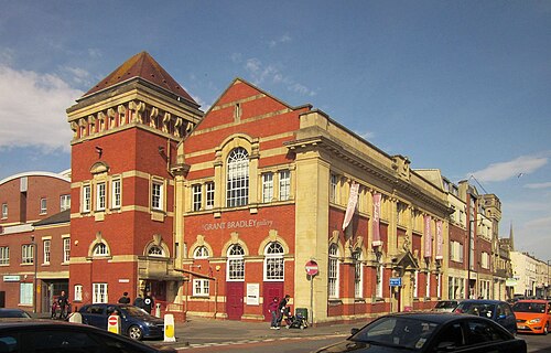 The former Bedminster Library on Bedminster Parade, built in 1914, a red brick and yellow stone building with a square tower and arched windows.
