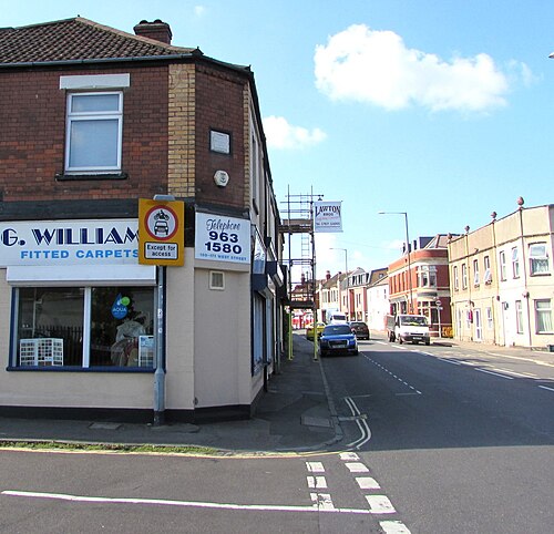 A two storey red brick shopfront at 169 to 171 West Street on the corner of Churchlands Road, white fascia signage over the window.