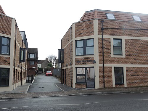 Chapel Barton, a narrow brick paved alleyway kept between the new student housing blocks built on the site.