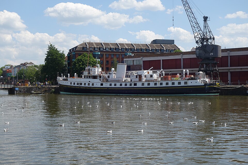 The black and white excursion ferry Balmoral moored broadside under crane 29, the M Shed's brick and glass front behind it.