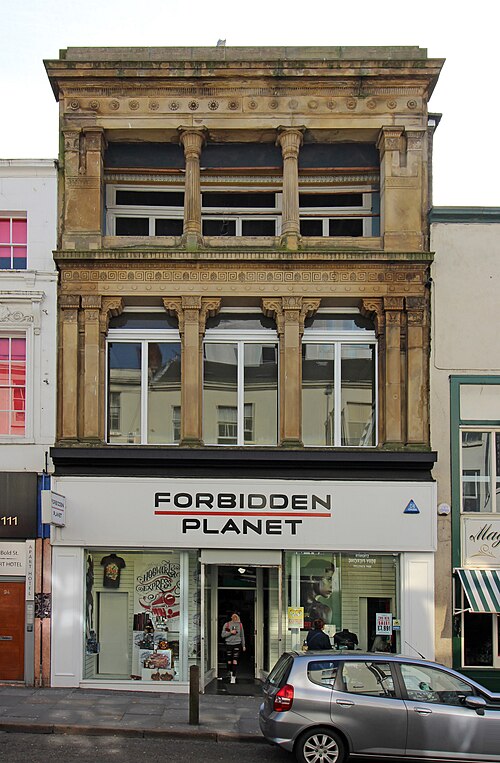 92 Bold Street, a stone Greek revival front of Corinthian pilasters and a Greek key frieze above a modern shop front.