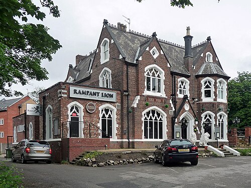 A red brick Gothic villa with pointed gables and white stone dressings on Anson Road, two stone lions flanking the entrance of what is now the Rampant Lion restaurant.