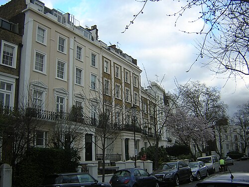 Cream stucco terraces with balustraded balconies on Chepstow Crescent.