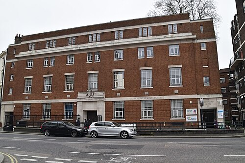 A three storey red brick civic building from 1937, City of Westminster carved in stone over the entrance.
