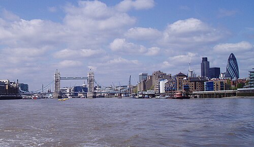 Looking west up the river from off Wapping, with Tower Bridge and the dome of St Paul's in the distance and the warehouse blocks of the north bank on the right.