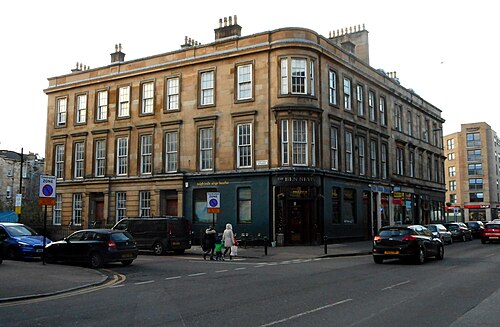 The Ben Nevis at the corner of Argyle Street and Corunna Street, a dark green pub front under a blond sandstone terrace with a corner bay.