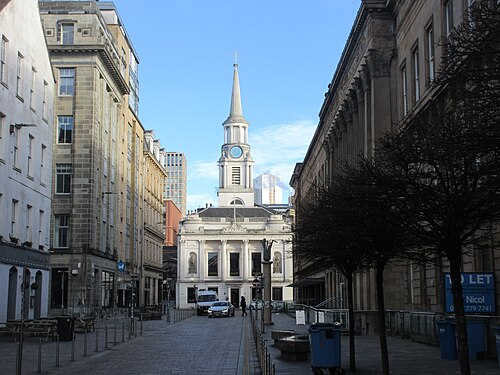 Hutcheson Street looking north to Hutchesons' Hall, a paved street between office blocks with the steeple above the portico at the end.