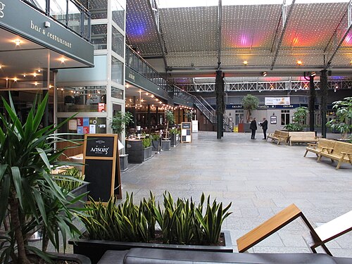 Merchant Square off Candleriggs, a courtyard roofed over with bar and restaurant fronts on two levels around it.
