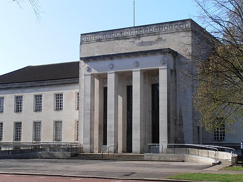 The Temple of Peace's plain fluted columns and stepped parapet, a lower stone wing running off to one side and a tree beside the steps.