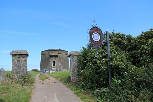 The round stone Martello tower on Balscadden Road, framed by its own stone entrance pillars.
