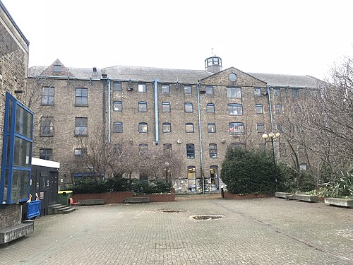 The former Powers Distillery kiln buildings on Thomas Street, now NCAD's School of Fine Art, brick walls around a paved courtyard.