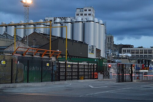 Storage tanks and low brick sheds inside the brewery complex.