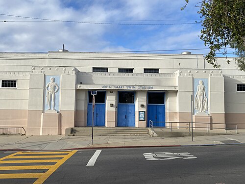 Urho Saari Swim Stadium, an art deco natatorium with a diver and a swimmer carved in relief on either side of the doors.