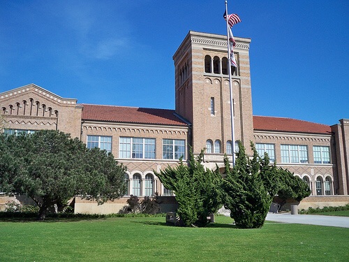 El Segundo High School's brick main building and bell tower, seen from the lawn along Main Street.