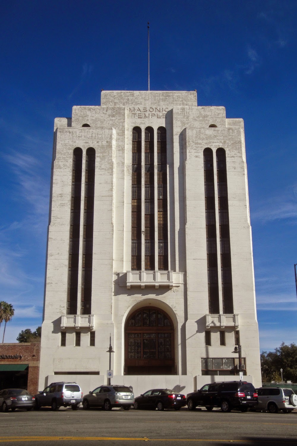 The Masonic Temple's Art Deco tower on South Brand Boulevard, fluted vertical piers rising to a lettered parapet.