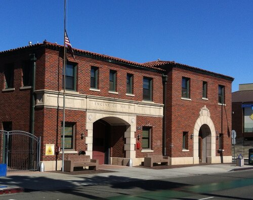 The Long Beach Engine Company No. 8 firehouse on Second Street at Claremont Avenue, a two story brick building with arched doorways and a tile roof.