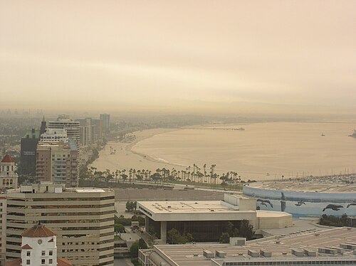 A hazy view east from a downtown high-rise, the beach and marina below and the rest of the skyline in the foreground.