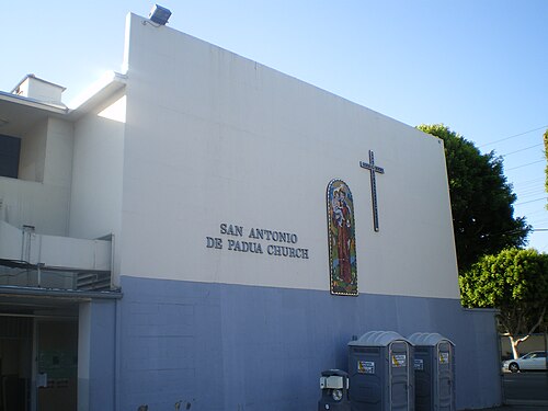 San Antonio de Padua Church on Fairview Avenue, a plain stucco wall with a small mosaic of the saint and a cross.
