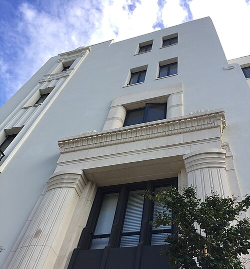 The Buena Vista Apartments, an Art Deco facade seen from below, fluted pilasters framing the entrance.
