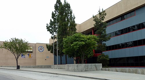 Francisco Bravo Medical Magnet High School, a modern building with banded blue glass and red trim.