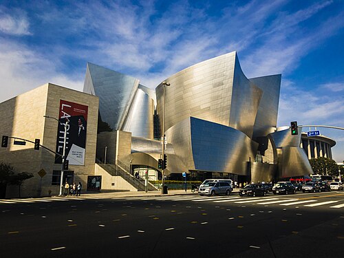 The Walt Disney Concert Hall's stainless steel curves, seen from the opposite corner of Grand Avenue and 2nd Street in full sun.