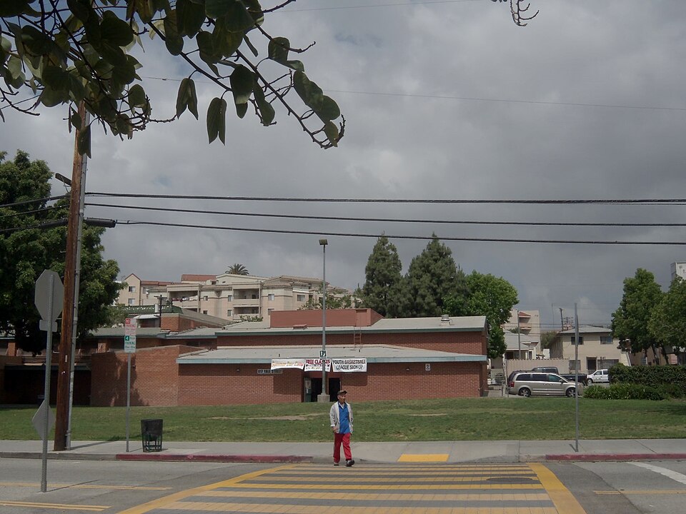 The Alpine Recreation Center at 817 Yale Street, a low brick building with a bulletin banner out front, apartment buildings behind it.