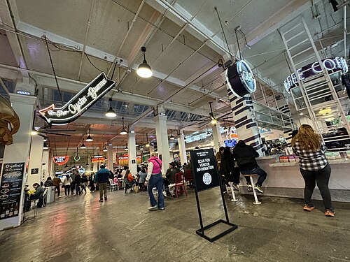 Grand Central Market, neon vendor signs and food stalls.