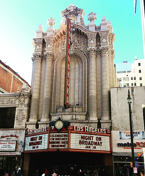 The Los Angeles Theatre's white Baroque facade and blade sign over the marquee.
