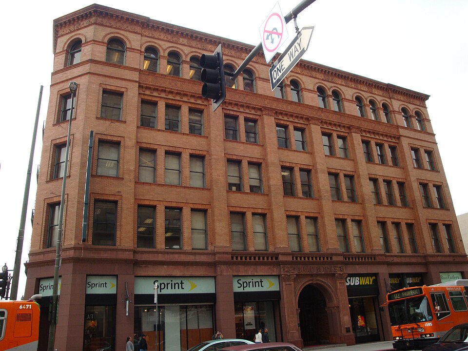 The Bradbury exterior at 3rd and Broadway, brick facade and the carved entrance arch.