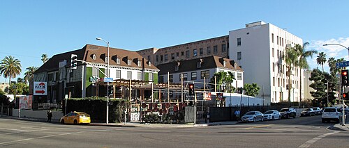 The Patio restaurant and an adjoining apartment building at Third Street and Kingsley Drive, a taxi waiting at the corner.