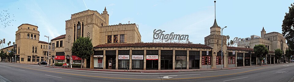 Chapman Market's arched colonnade of storefronts on Sixth Street, the building's own name spelled out in large letters on the roof.
