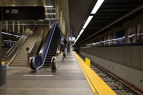 An escalator and stairway down to the platform at the Leimert Park Metro station on the K Line.