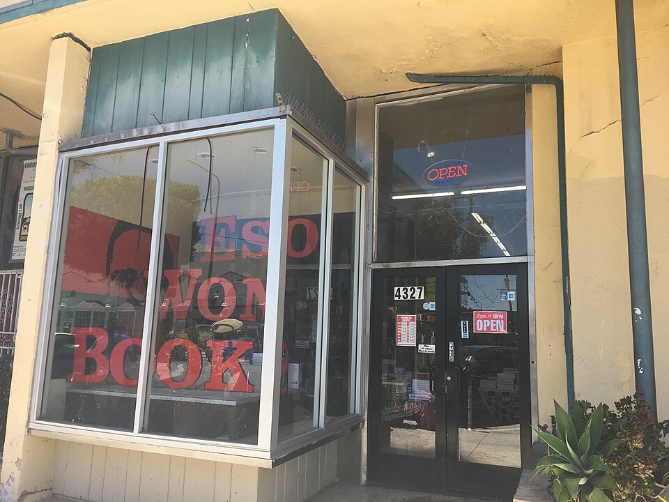 The storefront of Eso Won Books at 4327 Degnan Boulevard, red lettering in the window and the street number routed above the door.