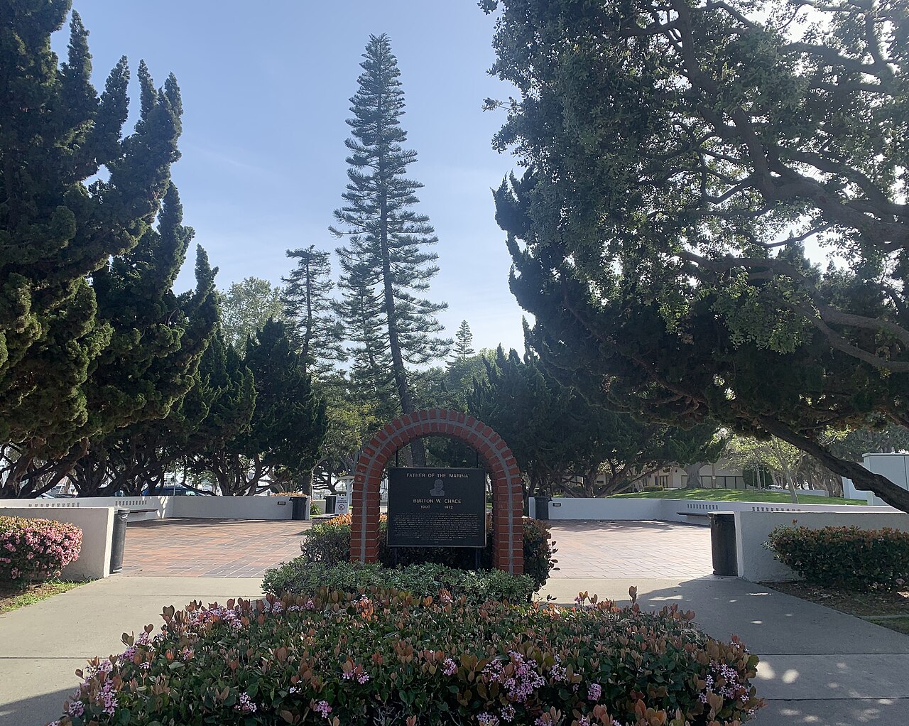 The park's brick paved entrance plaza, cypress and Norfolk pine around a brick memorial to Burton W. Chace, the marina's namesake.