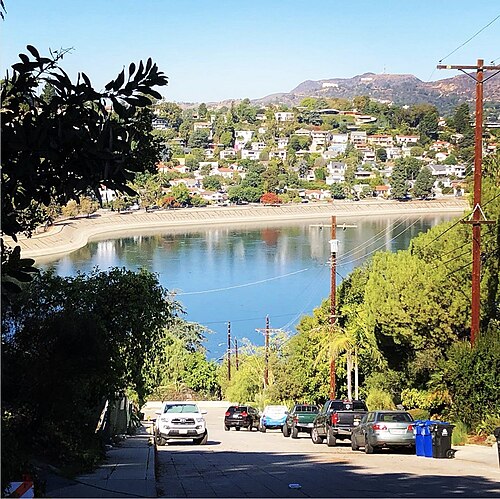The reservoir seen downhill from Baxter Street, with hillside houses and the Hollywood Sign on the ridge beyond.