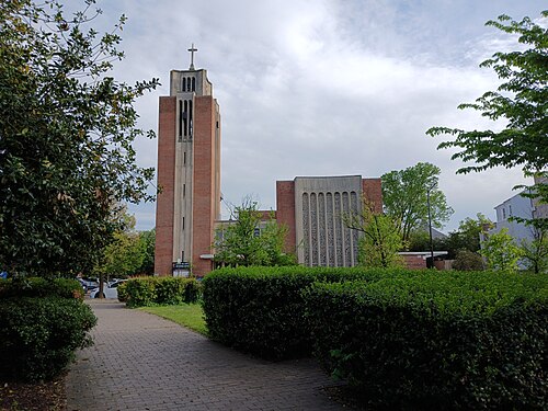 Capitol Hill United Methodist Church, a tall brick bell tower beside a lower sanctuary wing with a pierced concrete screen wall.